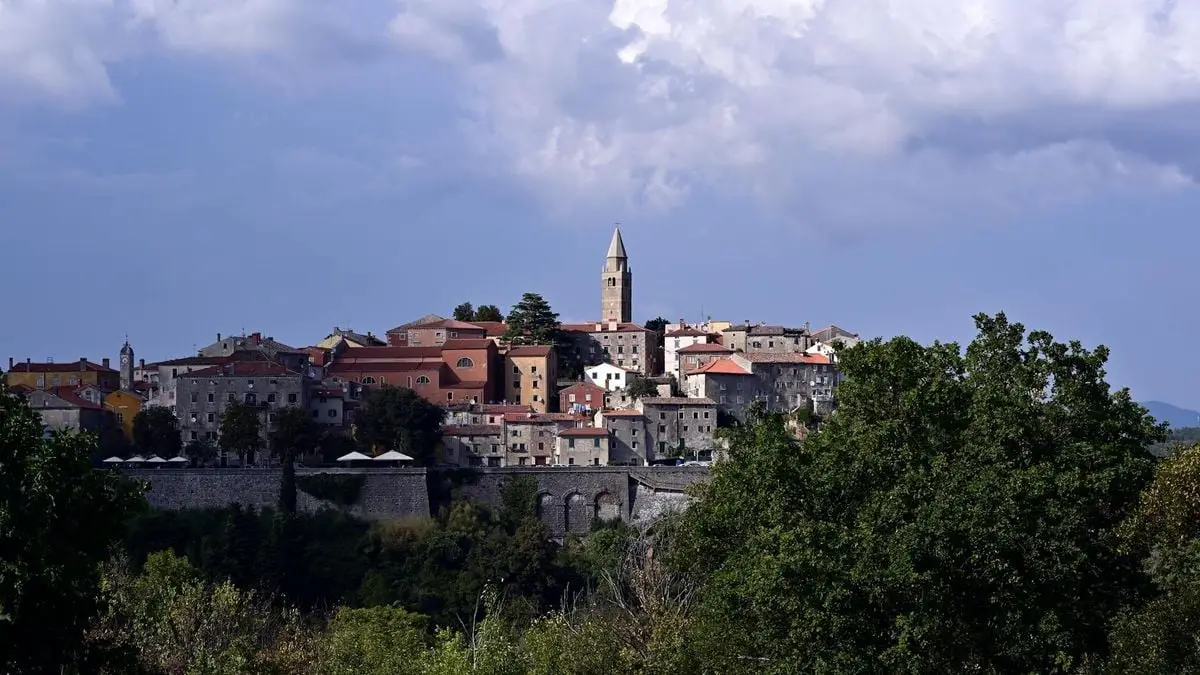 Charming hilltop town of Labin under a blue sky in Istria, Croatia, showcasing medieval architecture.
