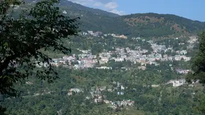 Breathtaking panoramic view of Kedarnath, nestled in the lush Himalayan mountains.