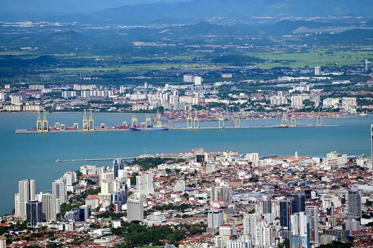 Stunning aerial view of George Town cityscape with bustling port in Penang, Malaysia.