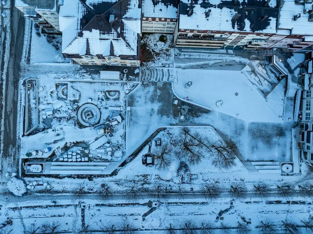 An aerial photo capturing a snow-covered urban landscape in Garešnica, Croatia, during wintertime.