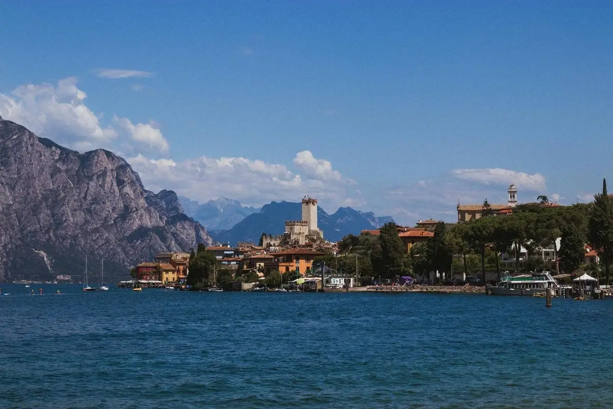 Scenic vista of Malcesine, Italy, with Lake Garda and mountains in the background.