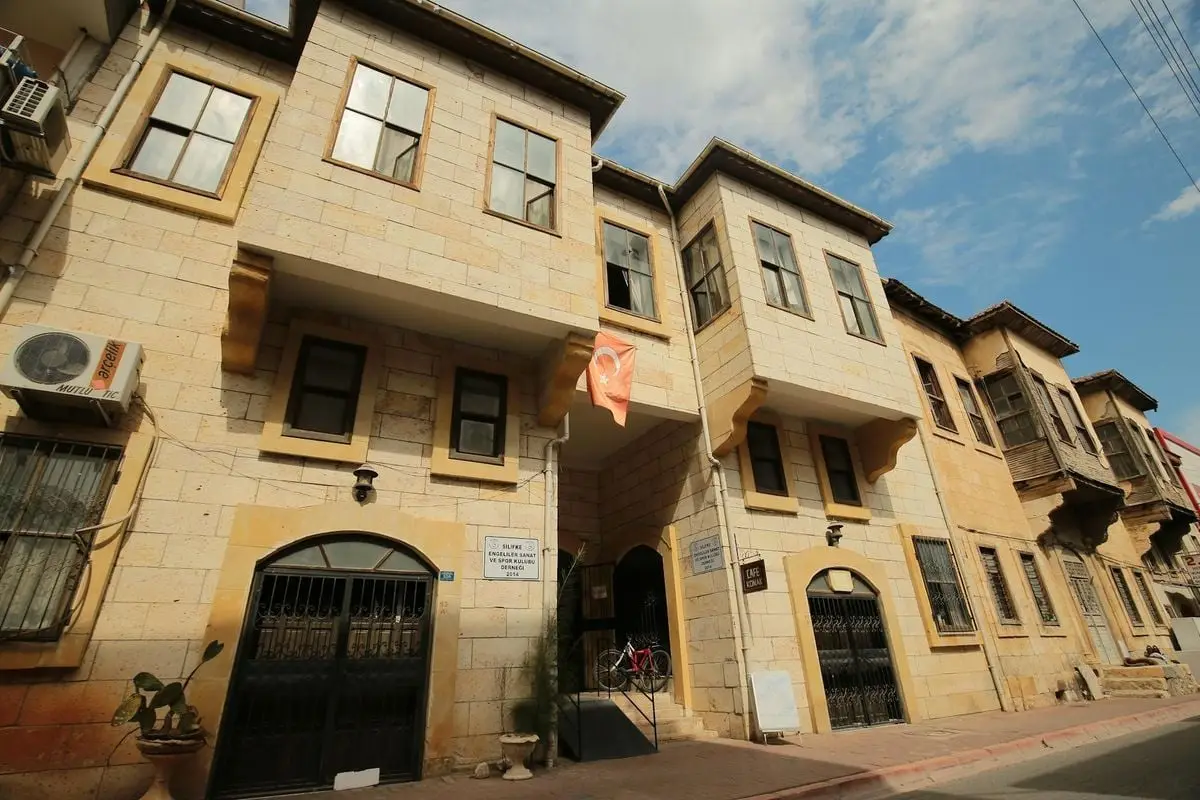 Explore traditional Turkish stone architecture with a hanging flag in a historic street setting.
