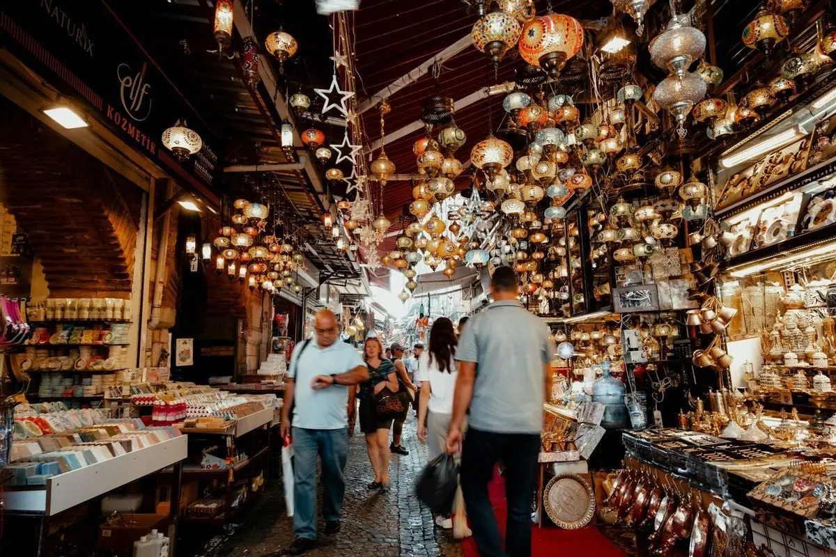 Explore the vibrant atmosphere and colorful lamps of Istanbul's Grand Bazaar, a famous shopping hub.