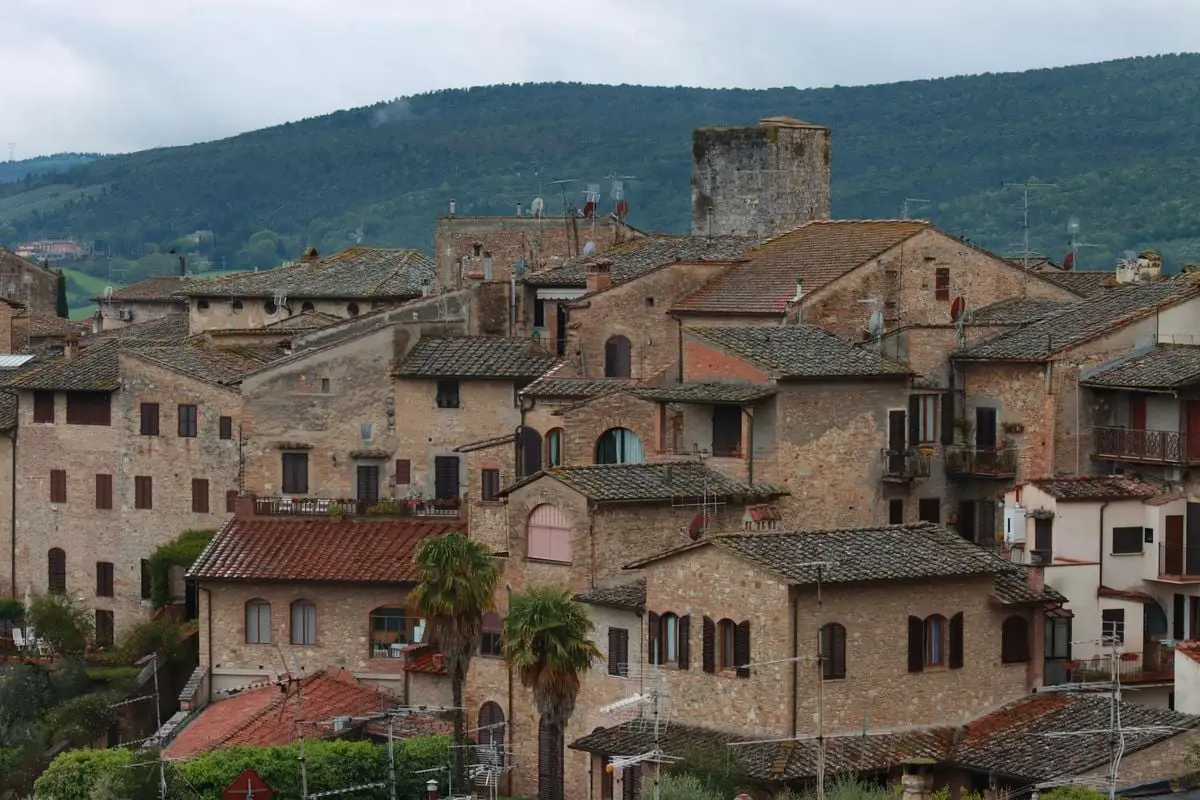 A picturesque view of a historic Italian town with ancient stone architecture.