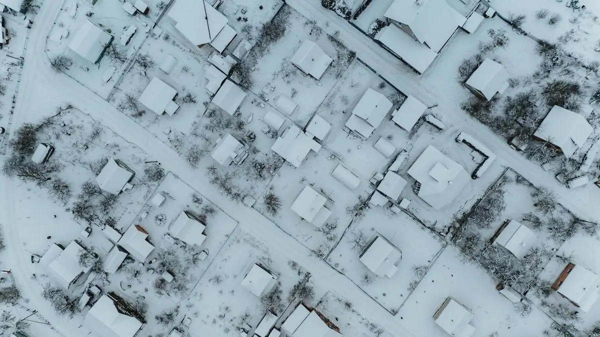 Aerial view of a snow-blanketed neighborhood in Minski rajon, Belarus, seen during winter day.