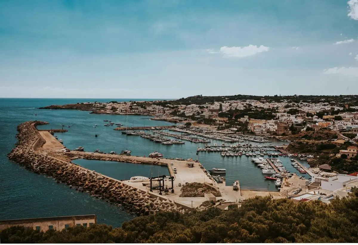A breathtaking aerial view of Otranto harbor and cityscape in Apulia, Italy, highlighting the waterfront and marina.