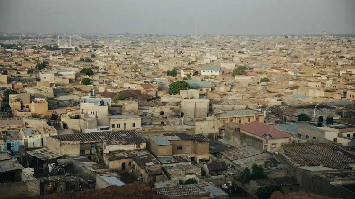 Aerial cityscape of Kano, Nigeria showcasing dense urban architecture and sprawling rooftops.