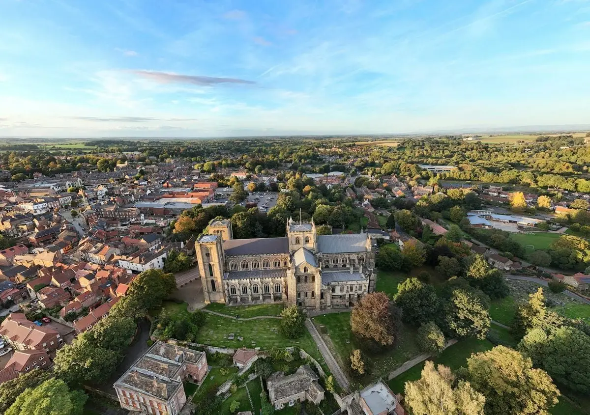 Stunning aerial view of Ripon Cathedral surrounded by the historic town and lush countryside.