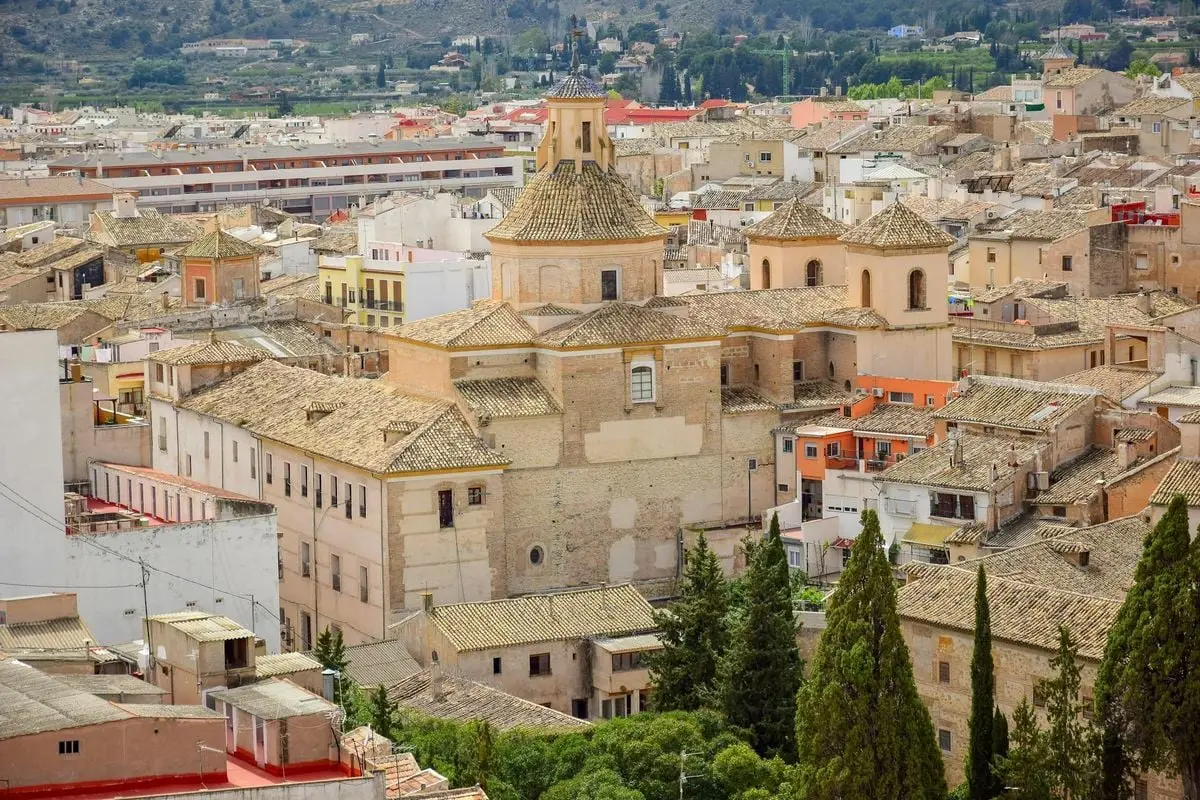 Scenic aerial view of Caravaca de la Cruz showing historical concrete buildings and urban landscape.