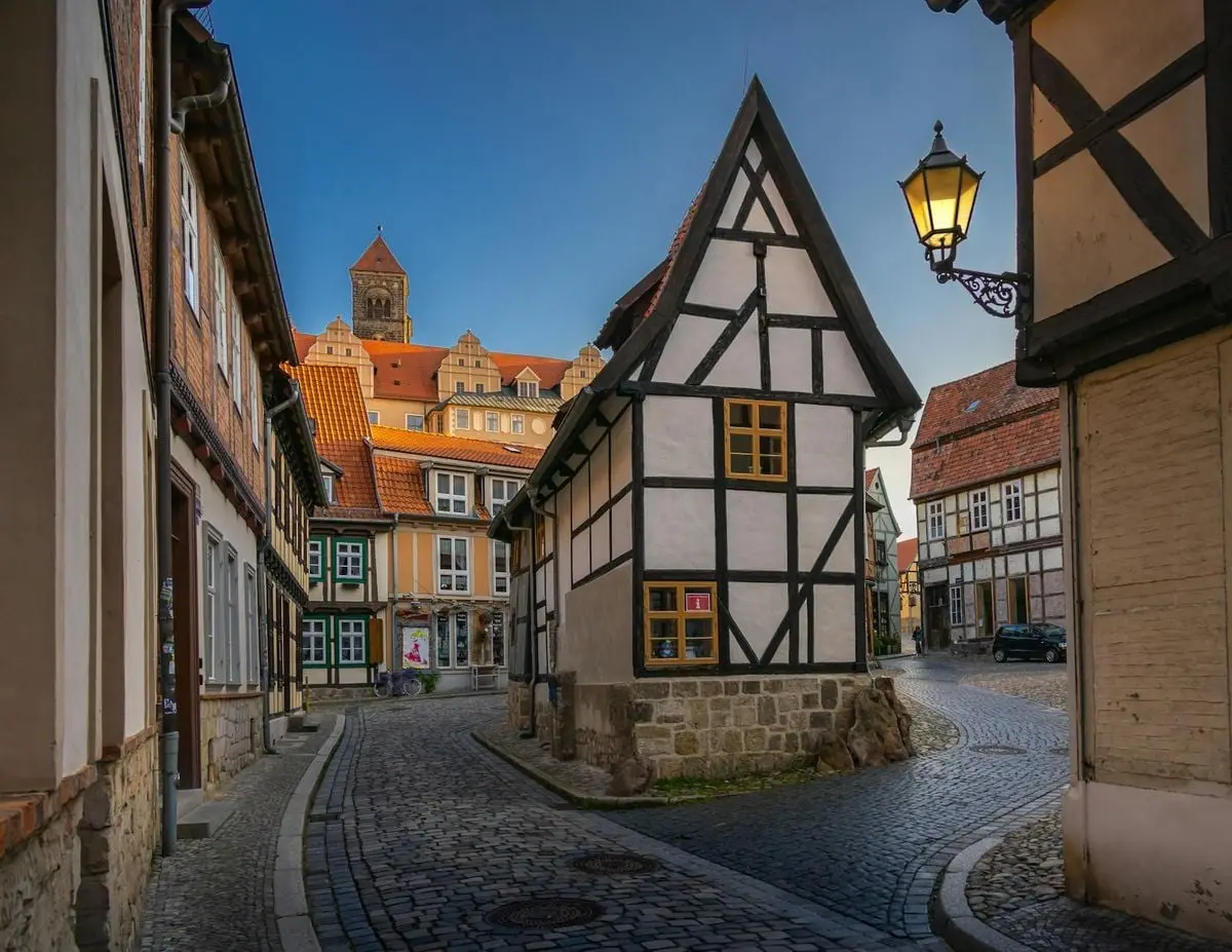 Explore the quaint medieval streets and timber-framed houses of Quedlinburg, Germany during a serene daytime stroll.