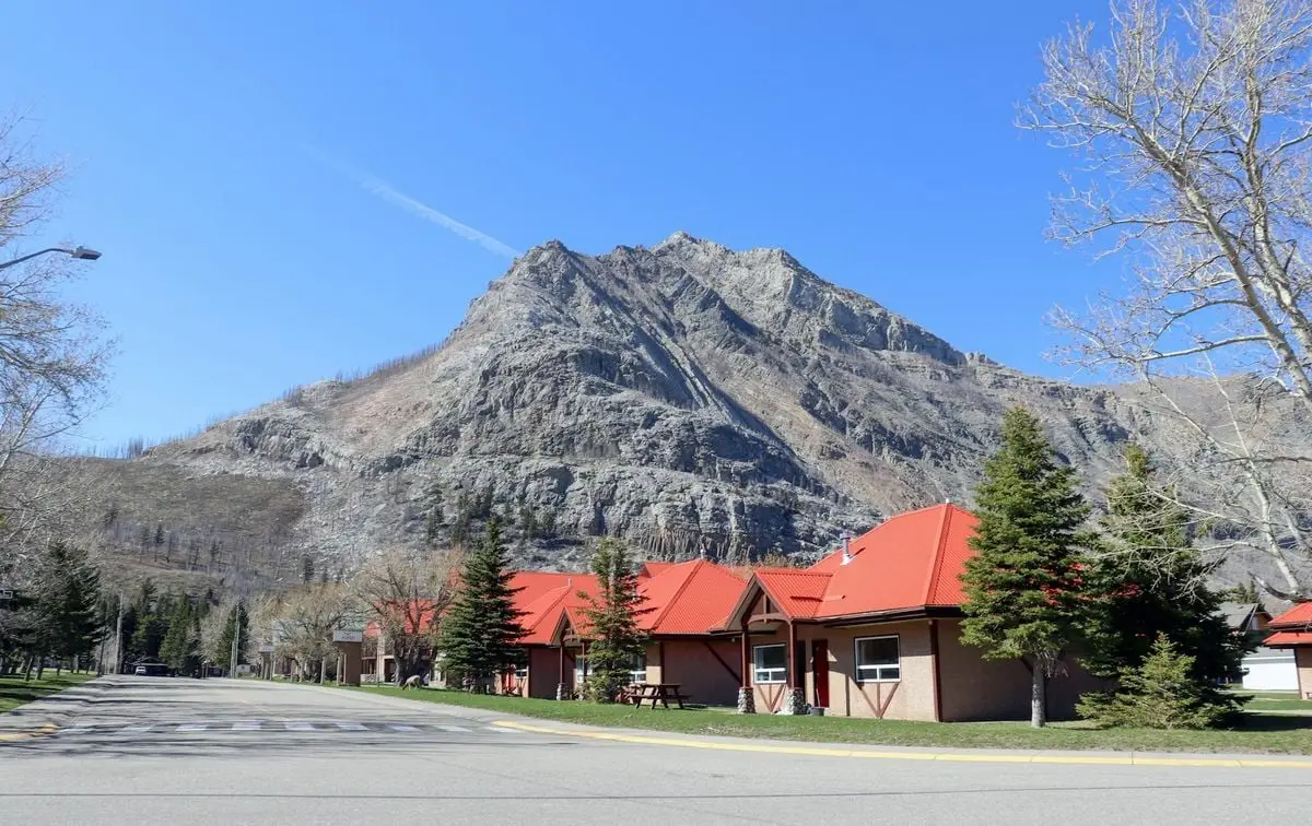 Charming mountain town with red-roofed buildings and a clear blue sky.