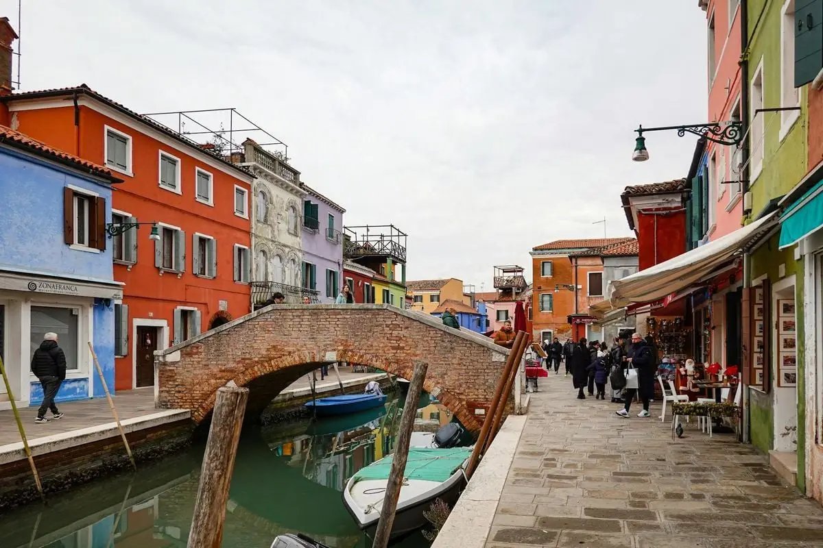 Explore the vibrant and colorful houses along the canals of Burano, Italy, showcasing unique architectural charm.
