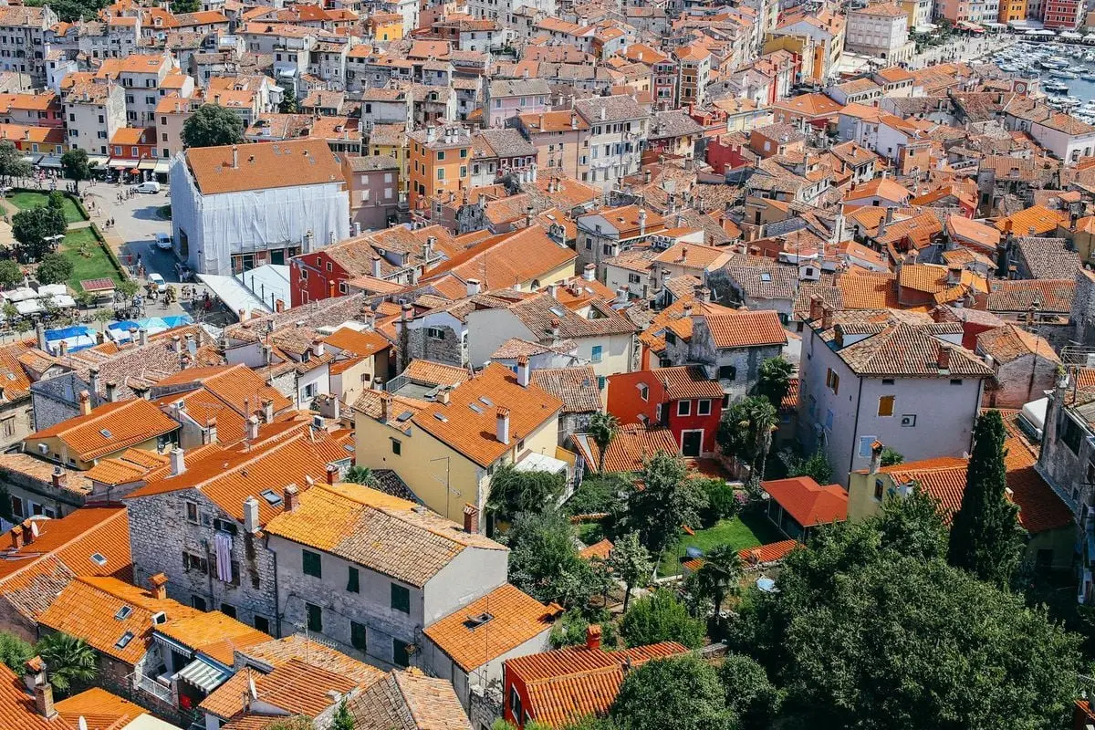 A vibrant aerial shot capturing traditional architecture and red rooftops in a European cityscape.