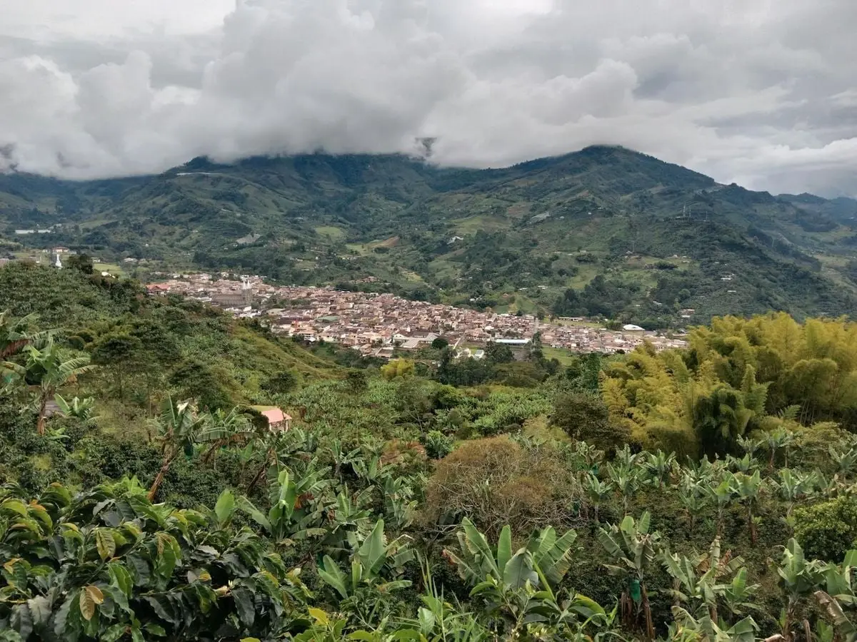 Scenic aerial view of Jardín, Colombia, highlighting the lush greenery and surrounding hills.