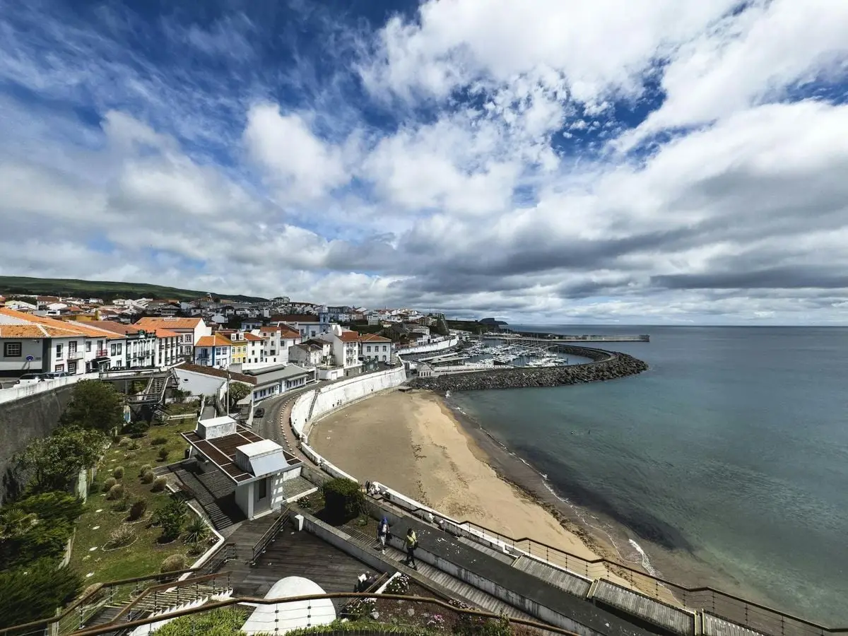 Panoramic view of Praia da Vitória's coastline with vibrant town architecture in Terceira, Azores.