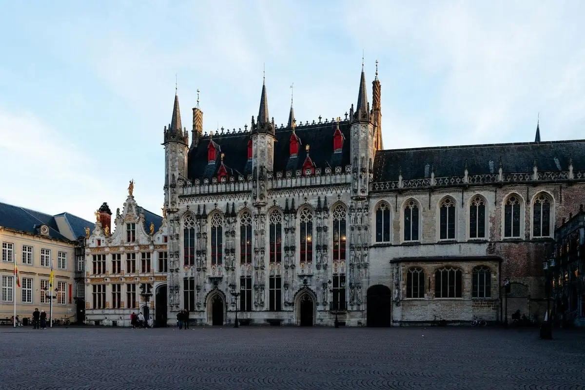 Historic Gothic architecture of the Bruges Town Hall in Flemish region, Belgium, during twilight.