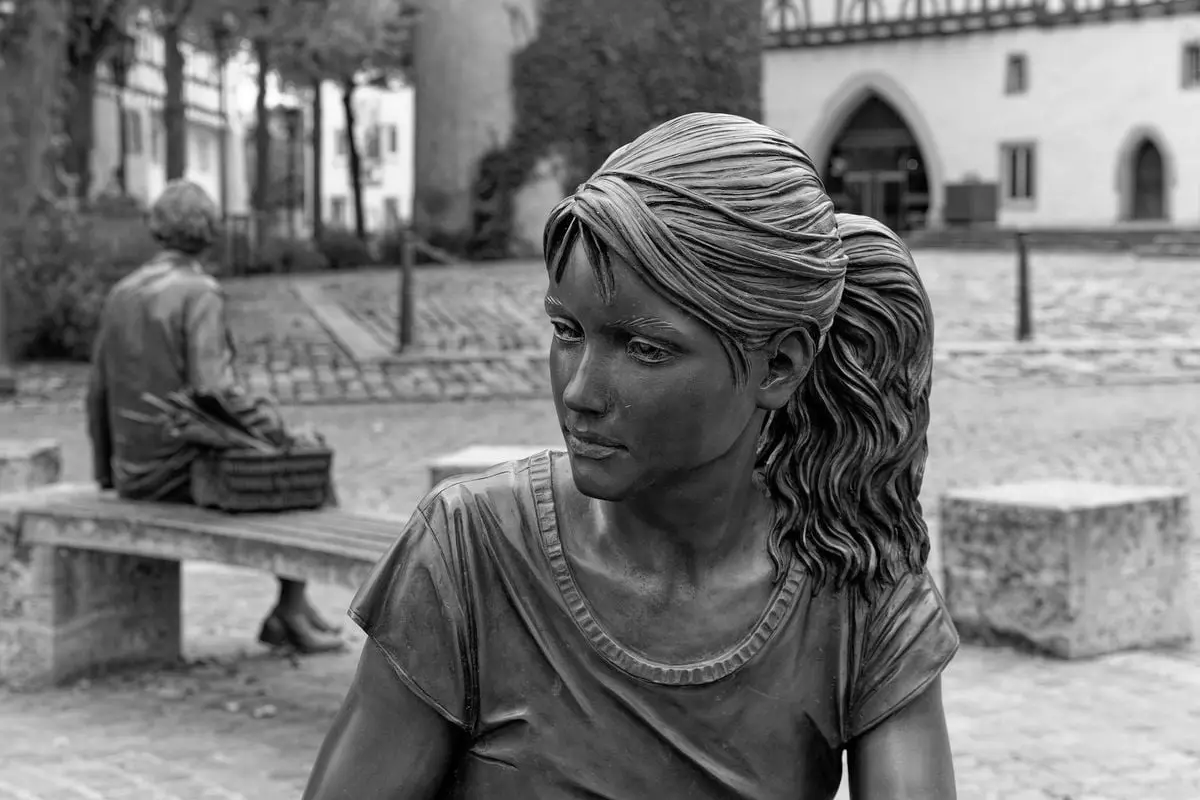 Bronze sculptures of people in historic Tauberbischofsheim, Germany's charming square.