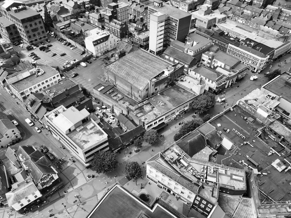 High angle aerial view of Luton's urban landscape, capturing buildings and streets in monochrome.