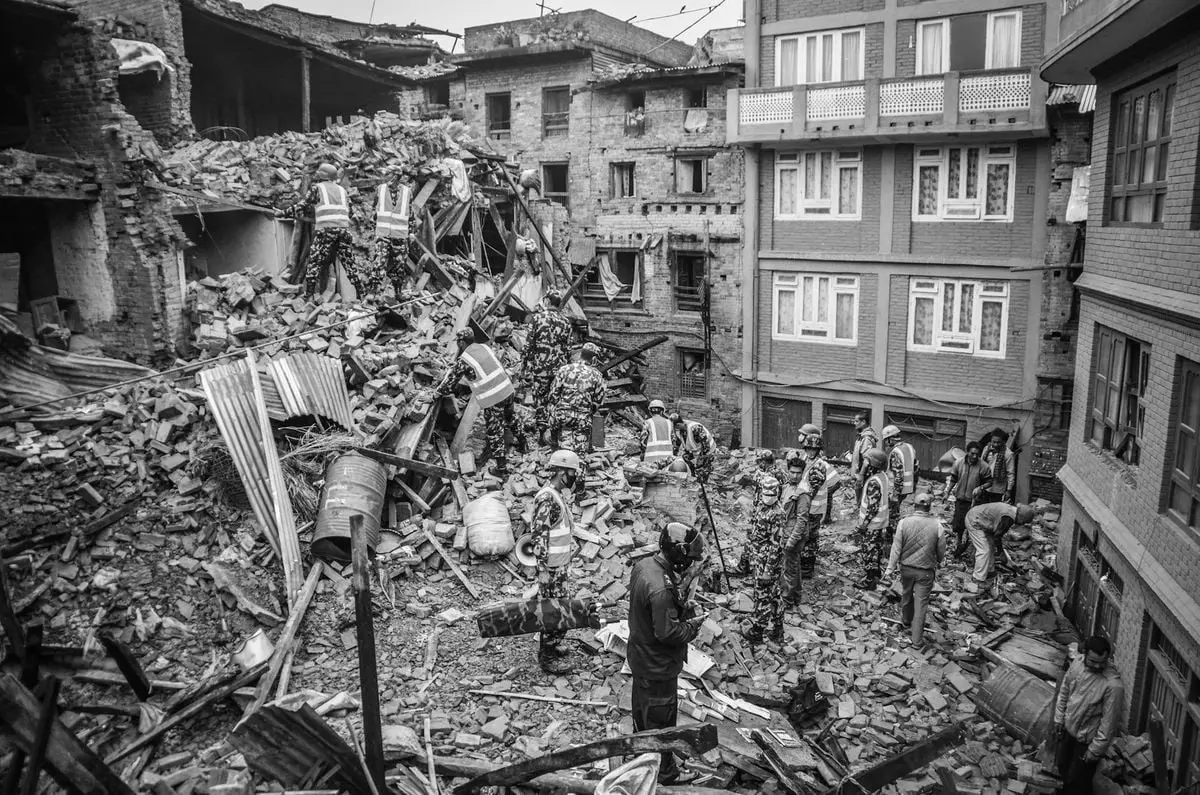 Rescue operations amidst earthquake destruction in Bhaktapur, Nepal. Soldiers sift through rubble.