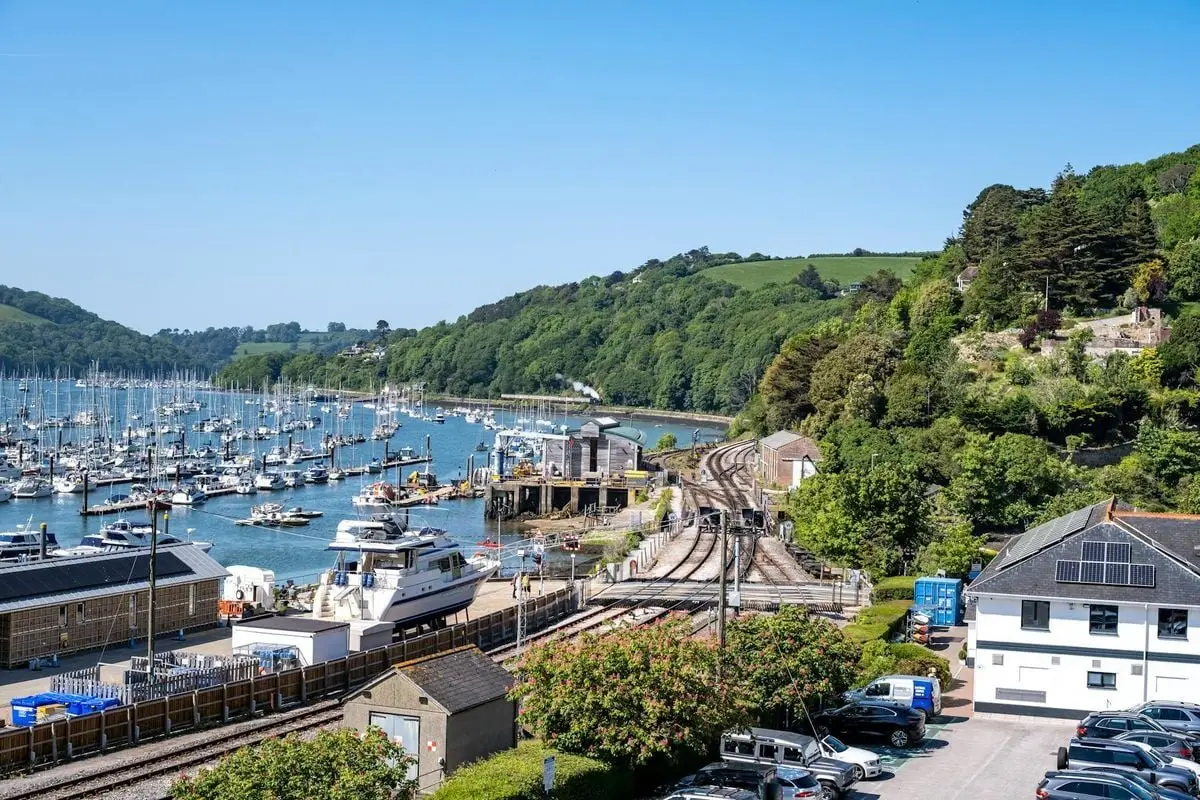 Beautiful aerial view of Dartmouth marina, railway, and lush landscape.