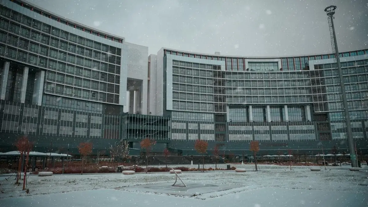 A panoramic view of a modern building in Istanbul covered in snow during winter.