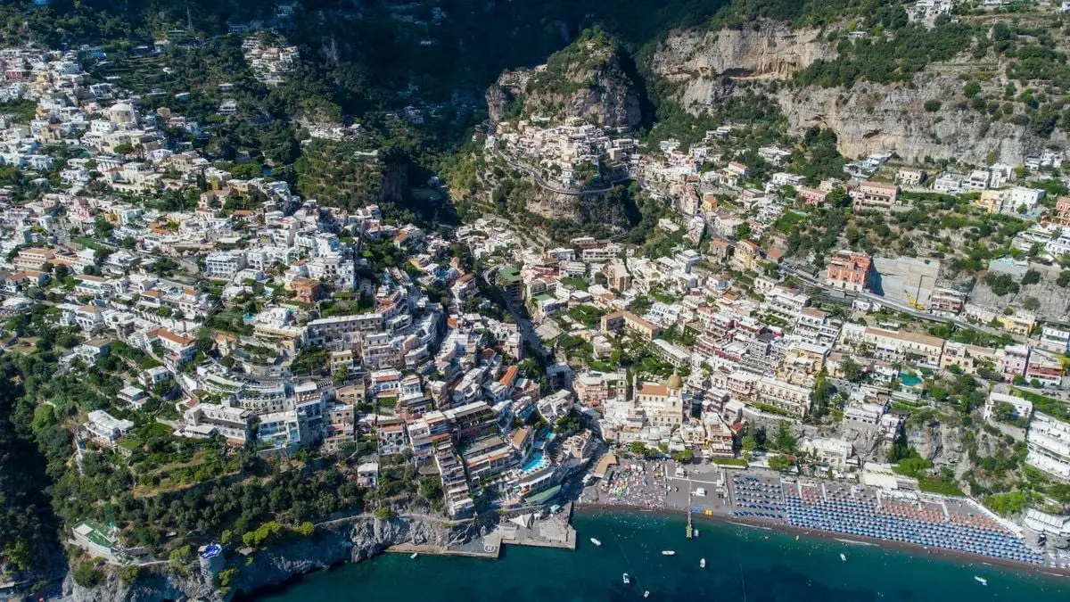 Stunning aerial view of Positano's colorful cliffside buildings and Mediterranean sea.