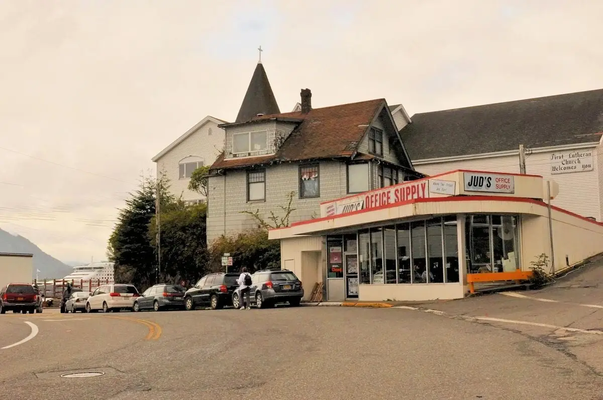 Street scene depicting a historic church and office supply store, capturing urban charm.