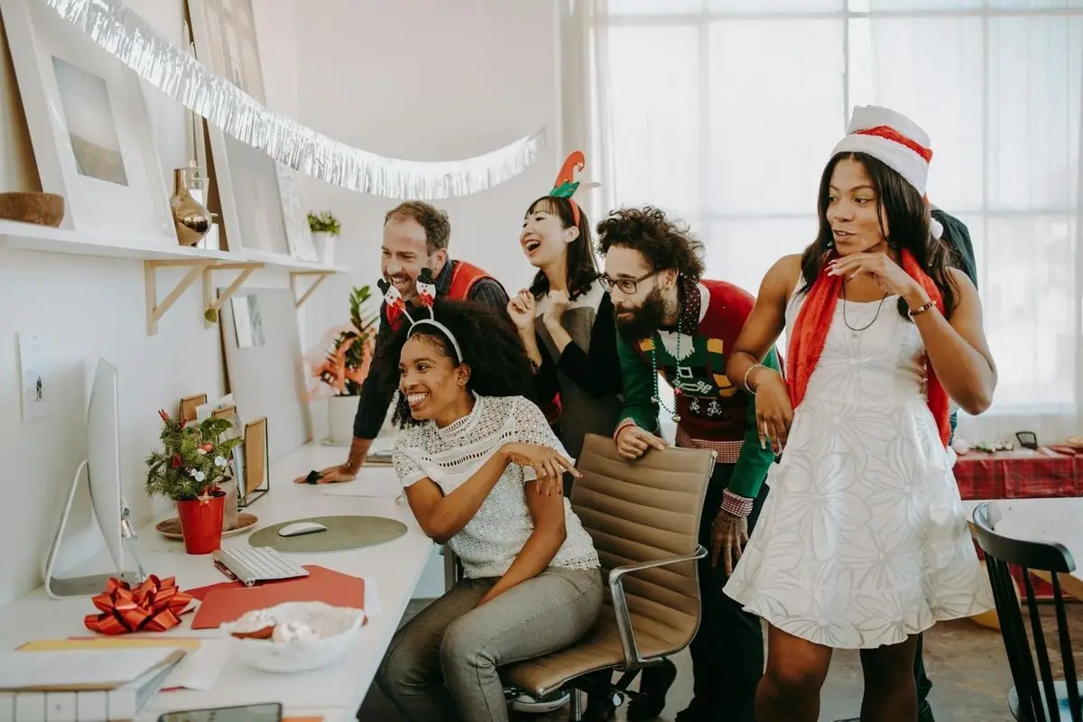 Diverse colleagues enjoy a festive Christmas party in the office, bonding and celebrating together.