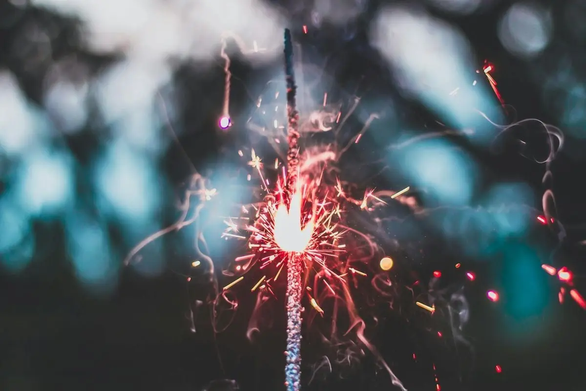 A close-up of a sparking sparkler with vibrant colors, evoking celebration.