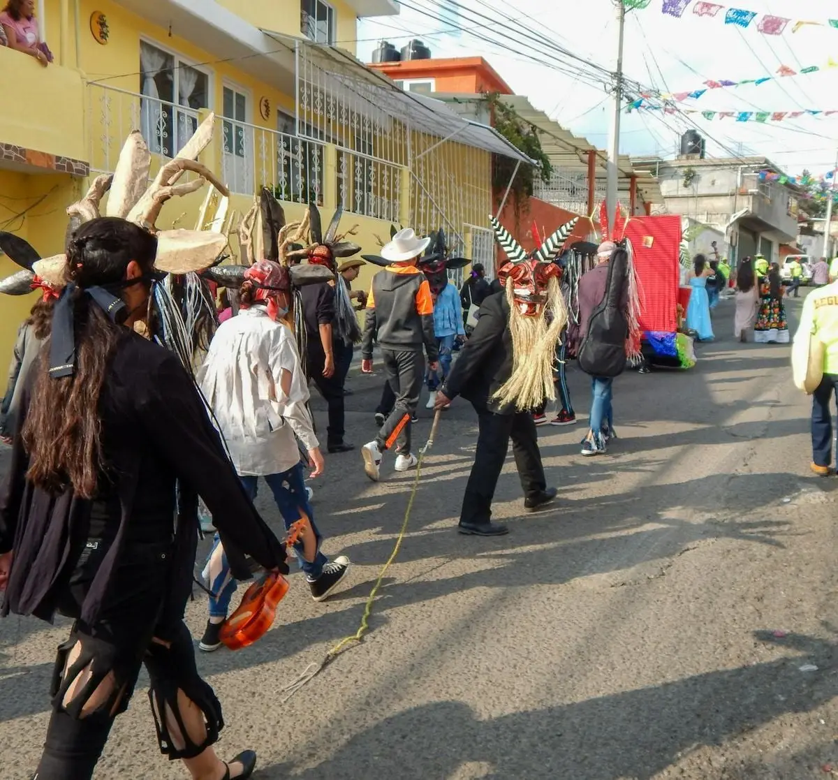 Vibrant street parade in Lerma de Villada, Mexico showcases traditional costumes and masks.