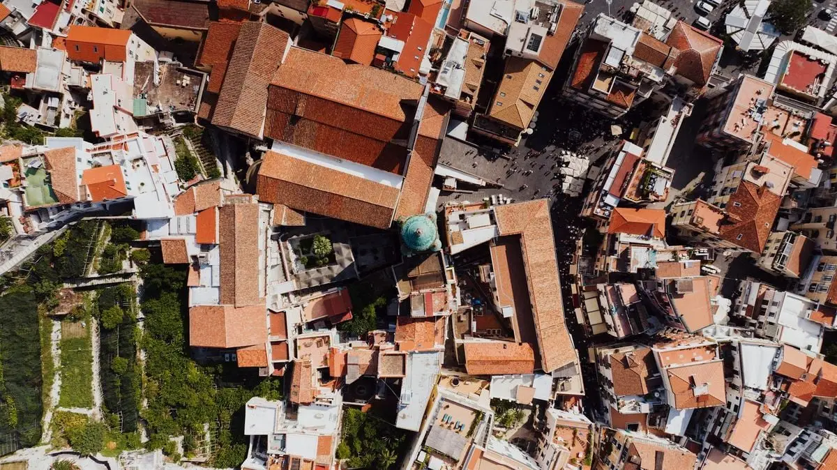 Stunning aerial shot of Amalfi, Italy showcasing the town's iconic red tiled roofs during daytime.