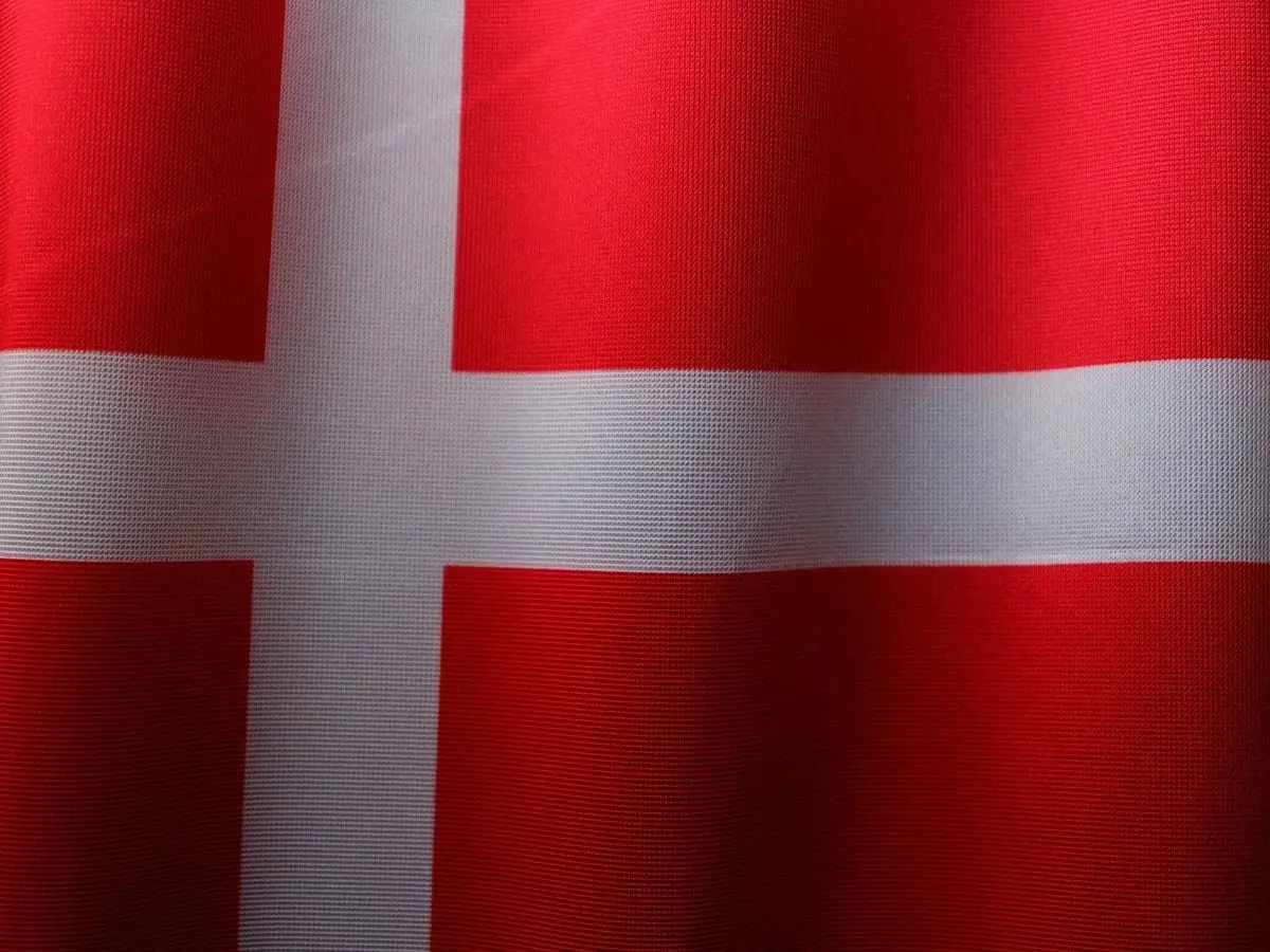 A detailed close-up of the vibrant red and white Danish flag, emphasizing patriotism and national pride.