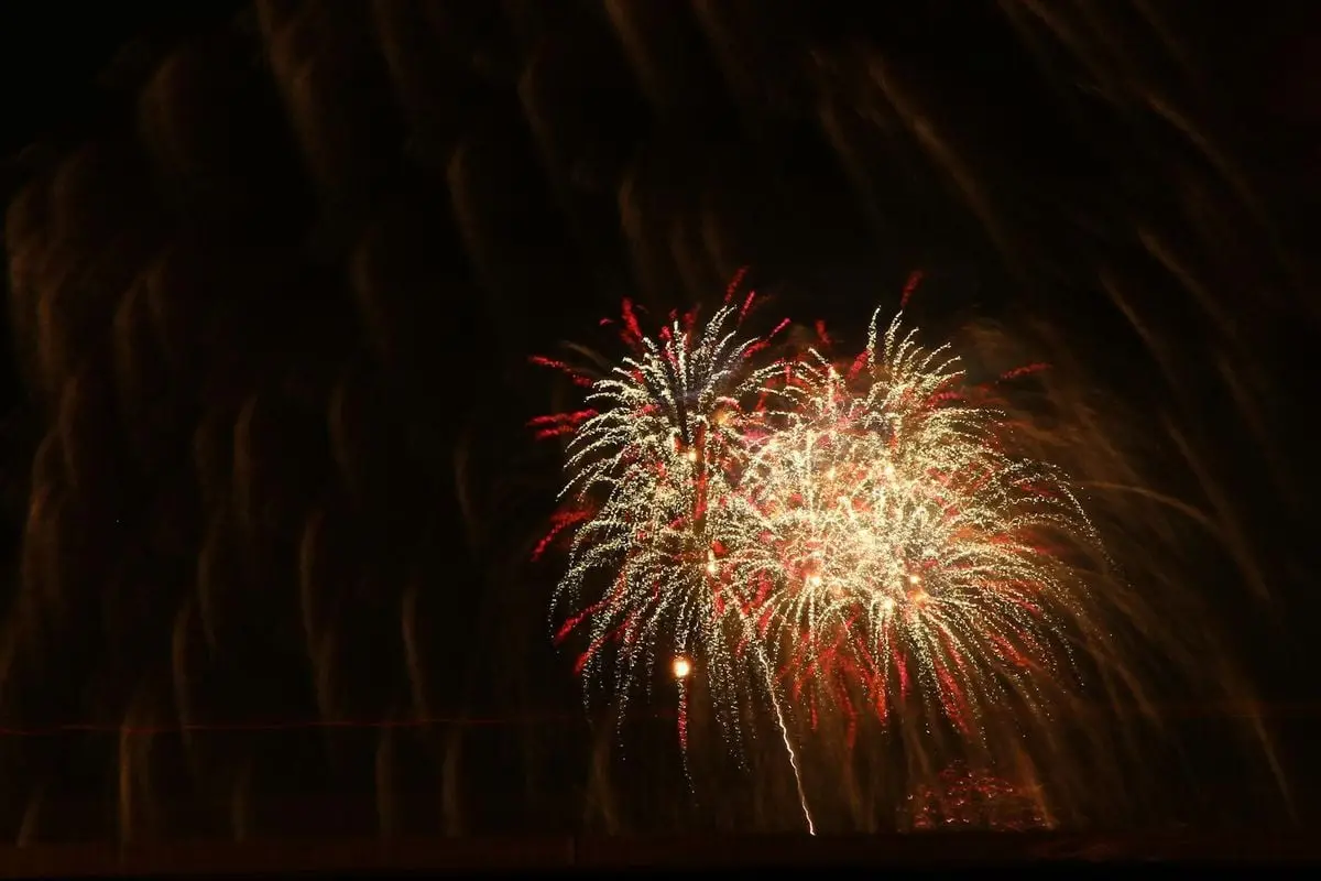 Colorful fireworks bursting against a dark sky, creating a festive celebration atmosphere.