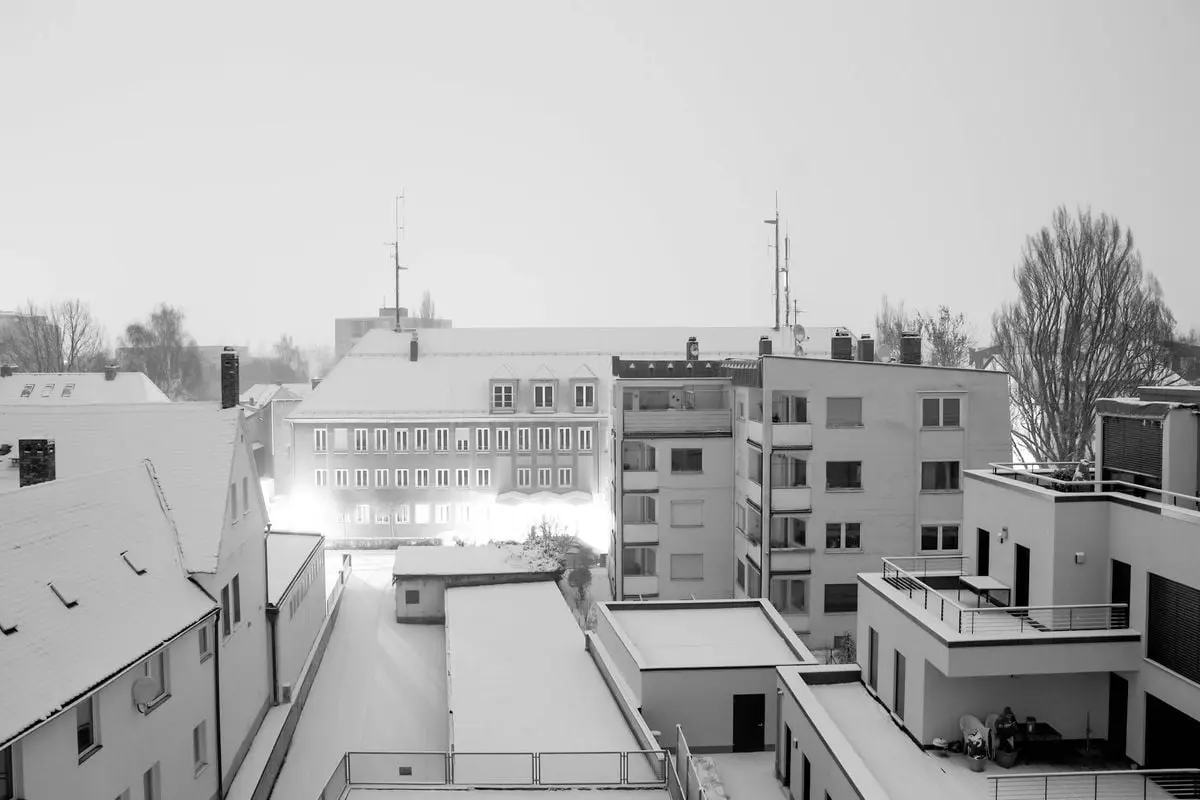Black and white winter view of snow-covered rooftops in Bayreuth, Germany.