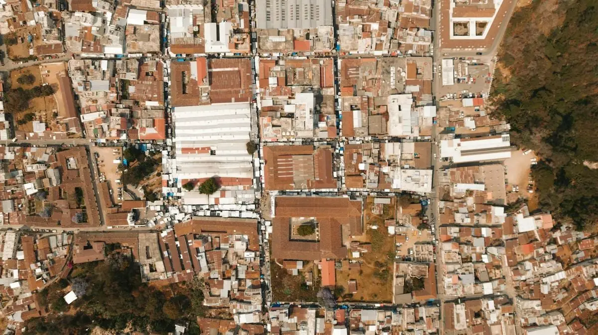 Top-down aerial photo capturing the intricate layout of town rooftops and streets.