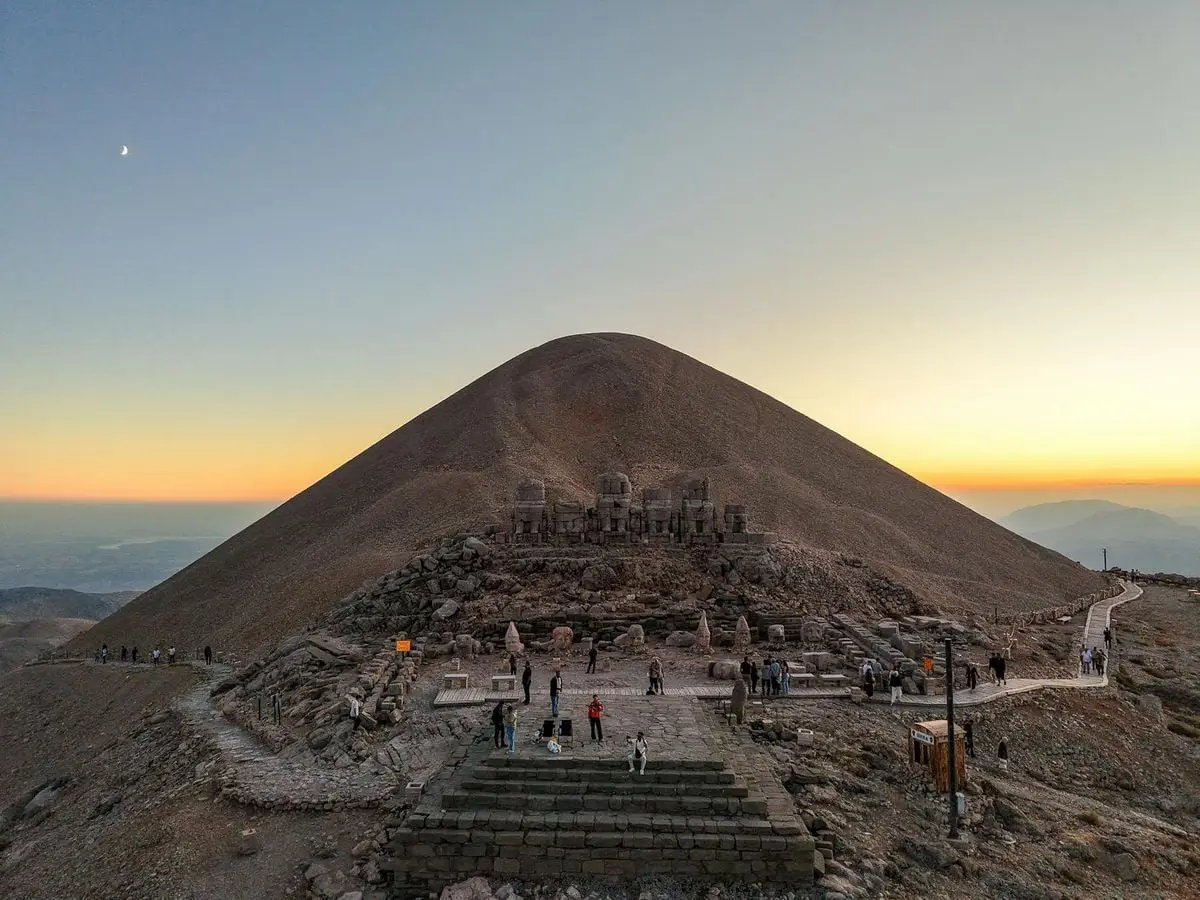 Stunning sunset over the ancient artifacts at Mount Nemrut, Adıyaman, Türkiye.