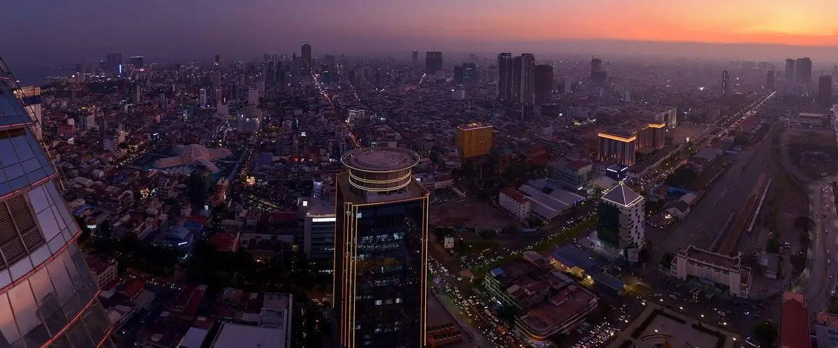 Stunning aerial view of Phnom Penh's cityscape at sunset, showcasing urban architecture.