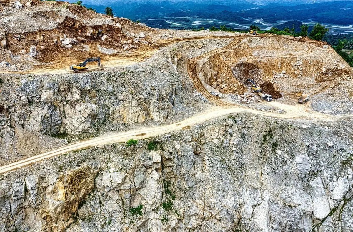 Aerial view of a quarry with heavy machinery in Purwakarta, West Java, Indonesia.