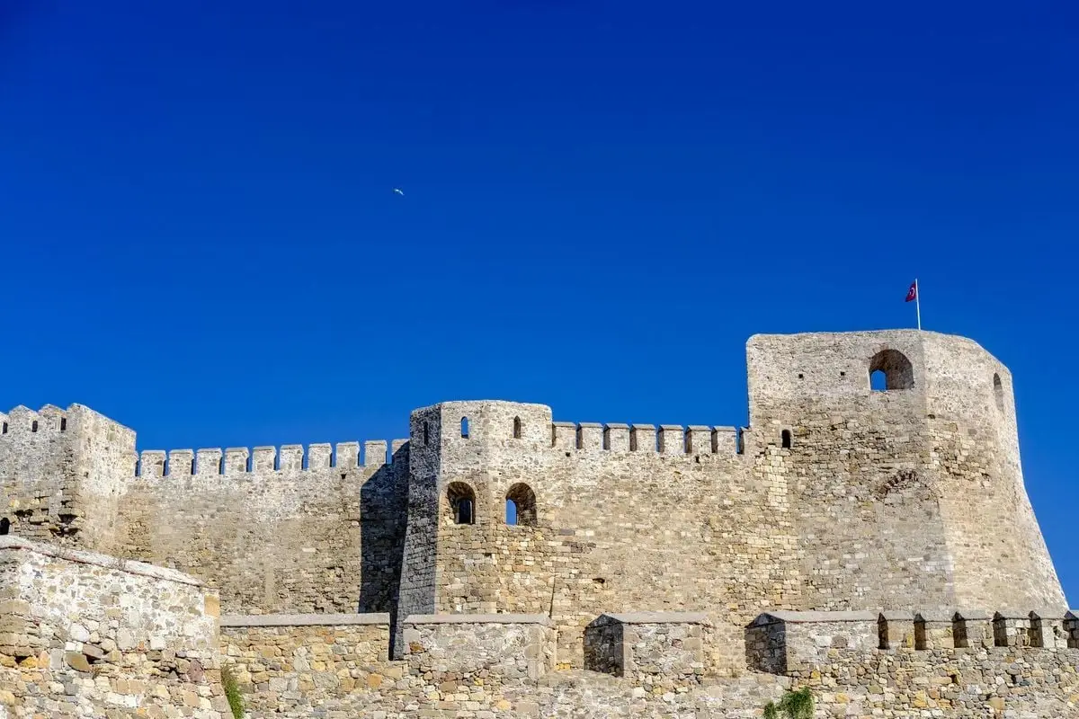 Beautiful view of Bozcaada Castle under a clear blue sky, highlighting its historic architecture.