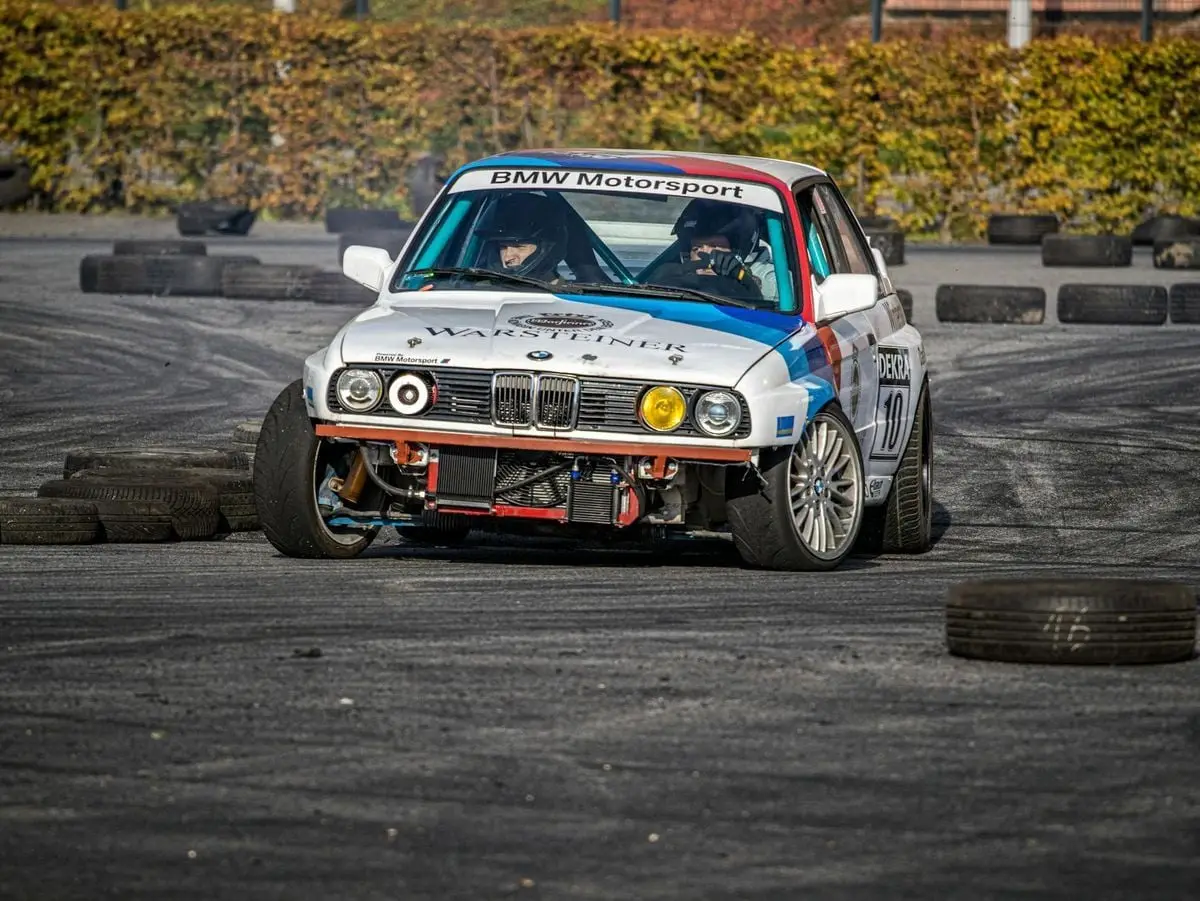 BMW motorsport vehicle speeding around a track with skillful handling in a race setting.