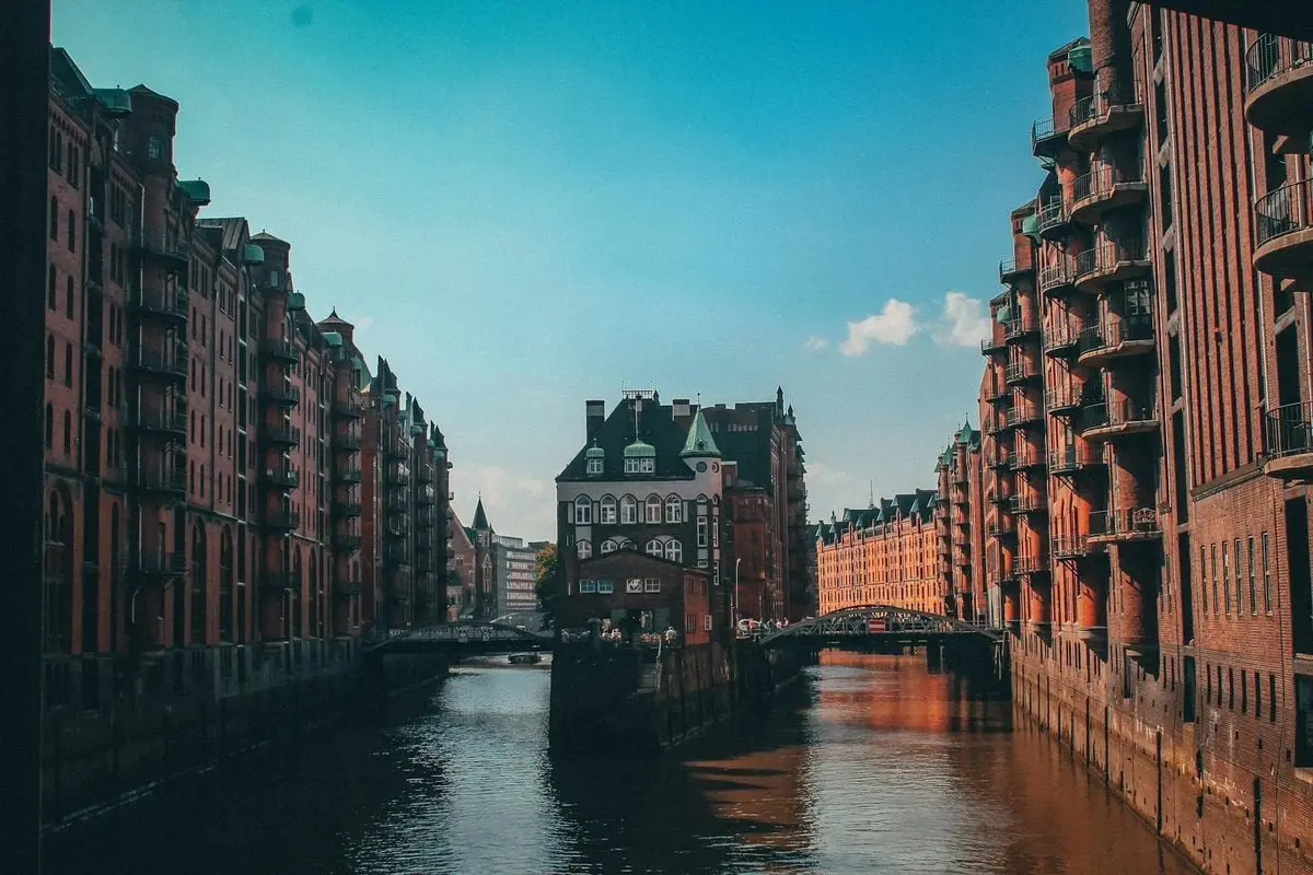 Stunning view of historic brick buildings lining a canal under a clear blue sky.