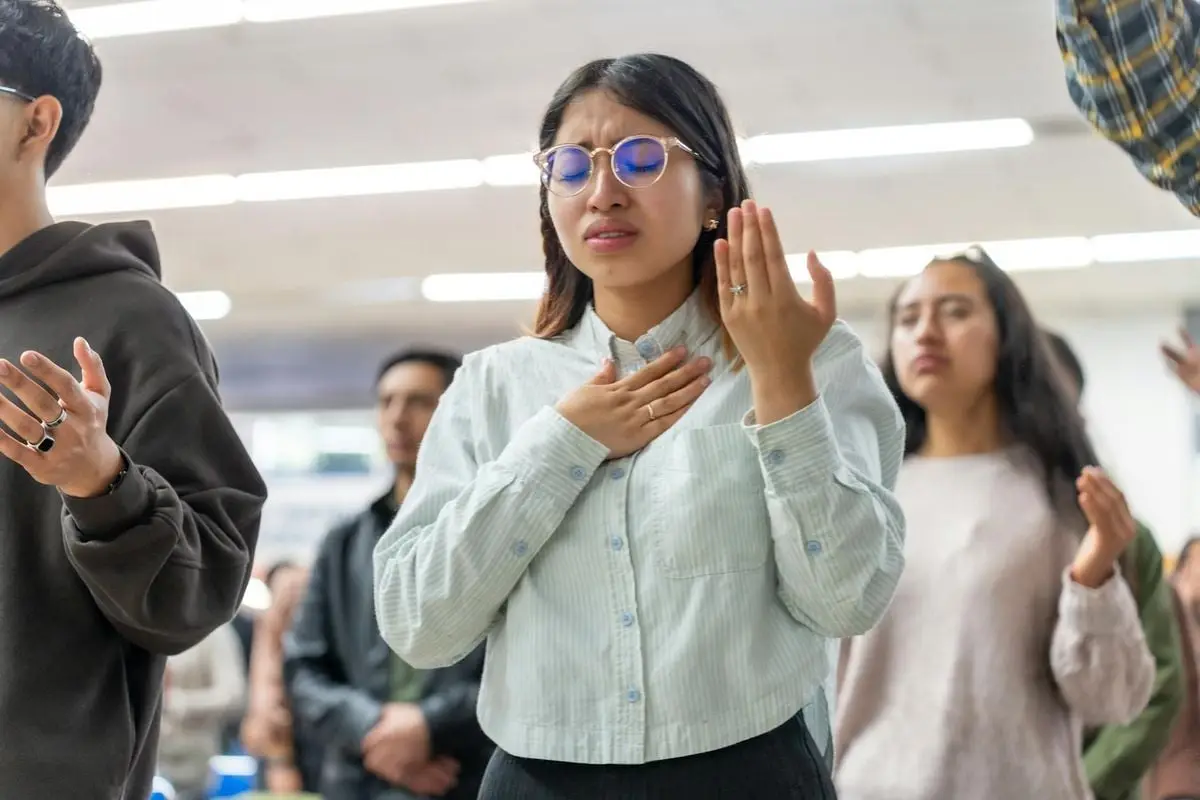 Group of young adults engaged in a Christian worship service in Mexico City, CDMX.