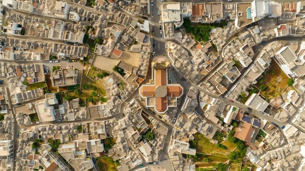 Drone shot capturing unique stone buildings of a historic town from above.