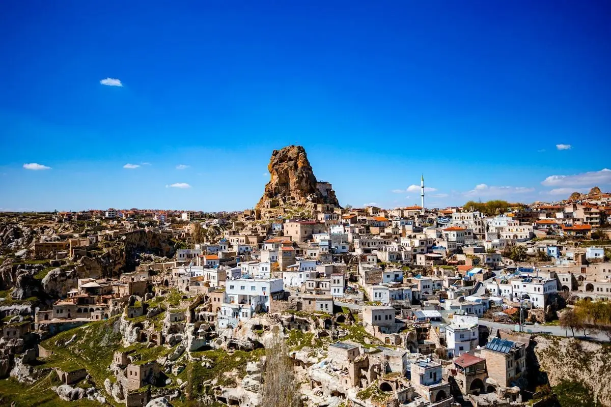 Explore the breathtaking rock formations and historic architecture of Ortahisar in Cappadocia, Turkey.
