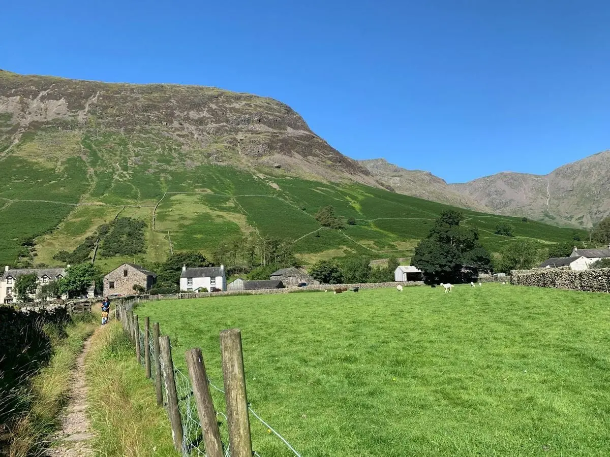 Charming rural landscape in Cumbria, England with rolling hills and a quaint village.