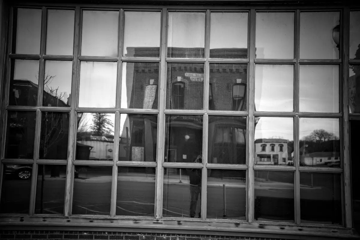 Black and white reflection of historic buildings in a window in Wabasha, Minnesota.