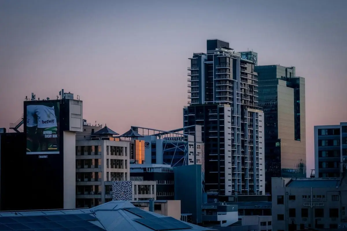 Modern buildings under a pastel sky in Cape Town, South Africa at sunset.