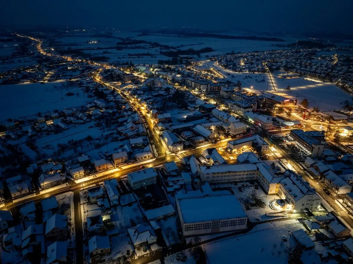 A stunning aerial view of snow-covered Garešnica in Croatia illuminated by streetlights at night.