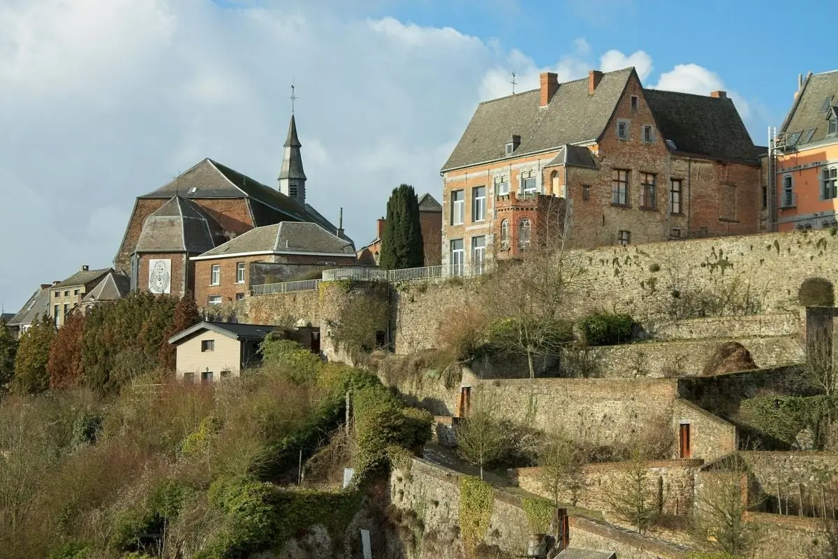 Discover the charming architecture of a historic Belgian town in this scenic countryside view.