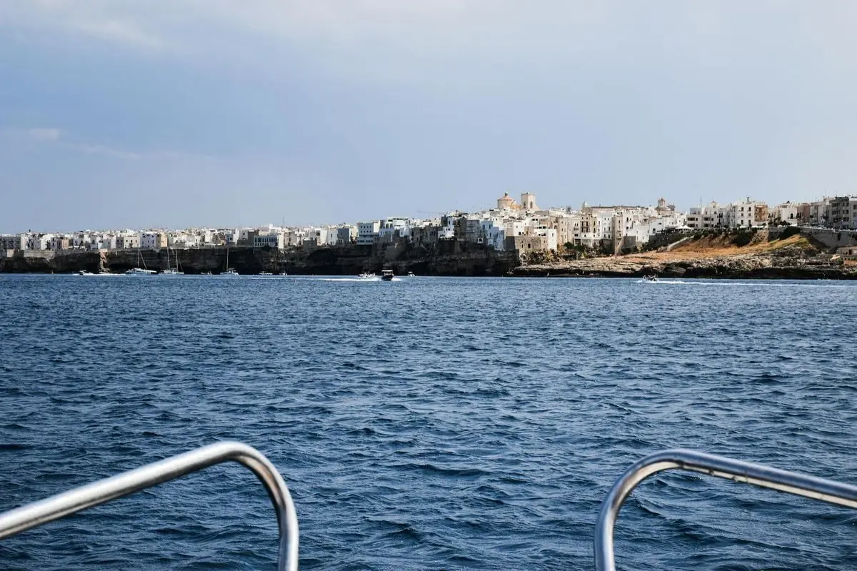 Explore the coastal beauty of Polignano a Mare, Italy from a boat view.